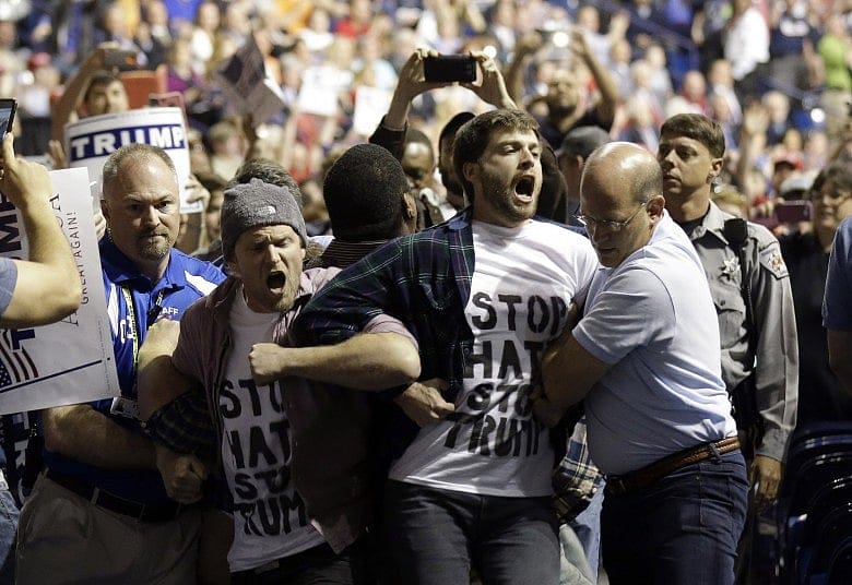 Trump rally goer charged with hitting black attendee