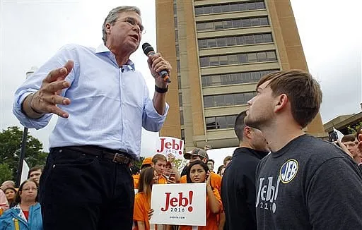 Bush campaign cuts pay, redeploys staff to early states