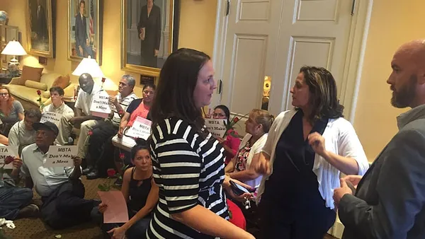 MBTA janitors camp outside Baker’s office to protest layoffs