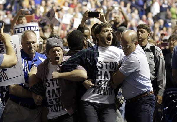 Trump rally goer charged with hitting black attendee